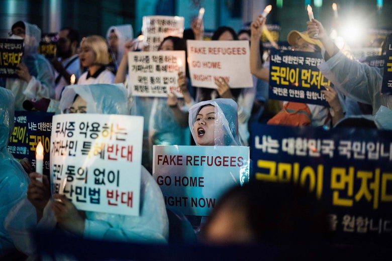 Anti-immigration activists attend a protest against a group of asylum-seekers from Yemen.